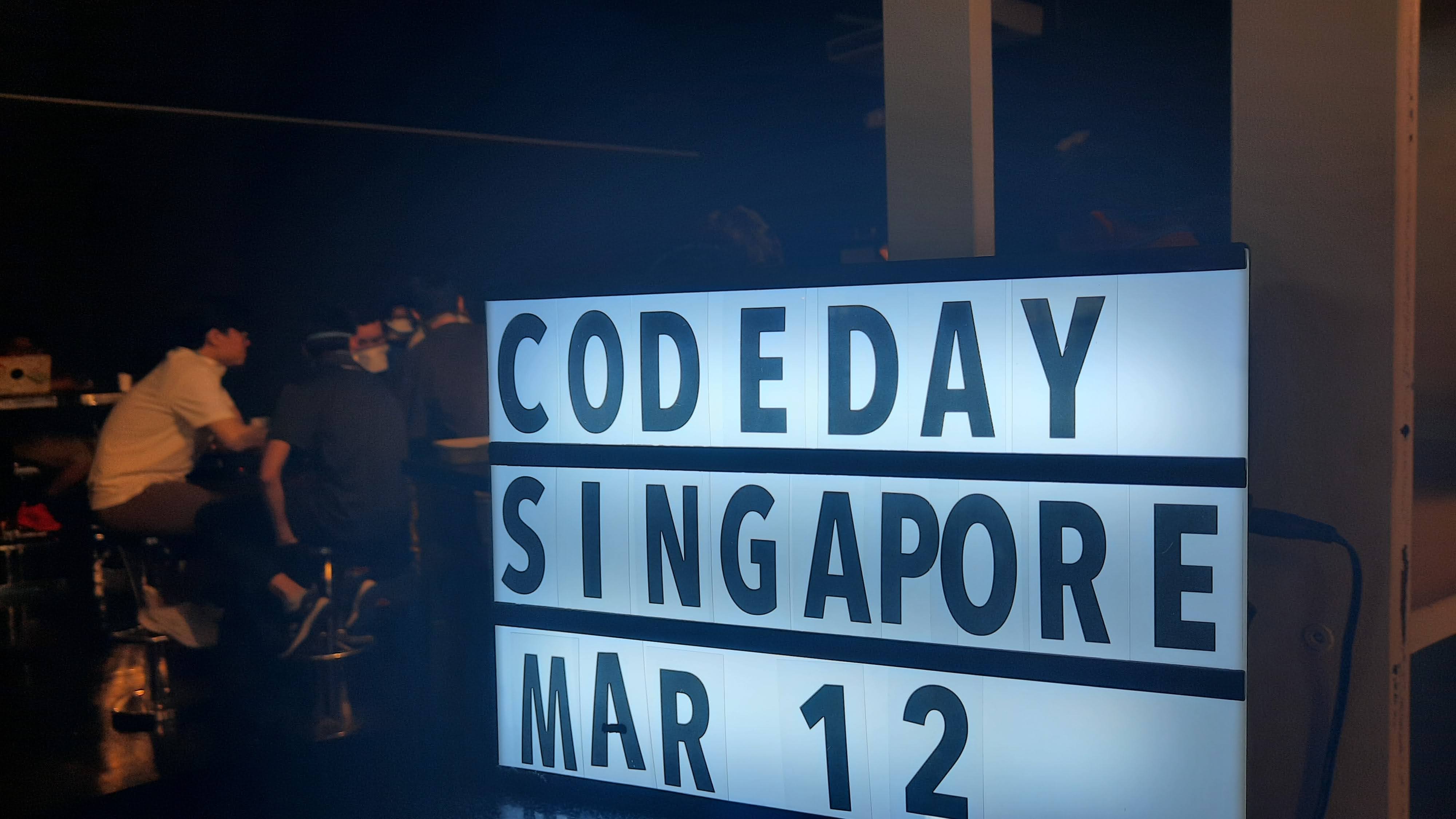 A box with the term 'CodeDay Singapore' illuminated on it