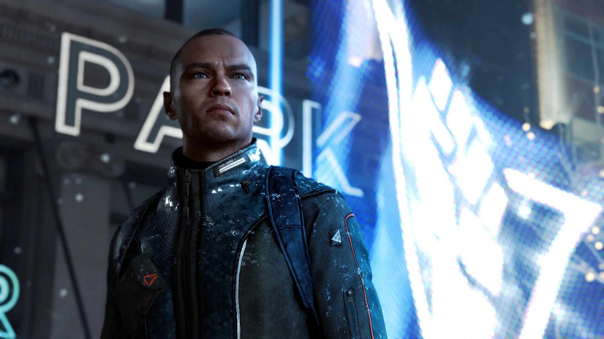 A humanoid android standing in the middle of a screen, with a digital flag in the background depicting a closed fist raised through a triangle.